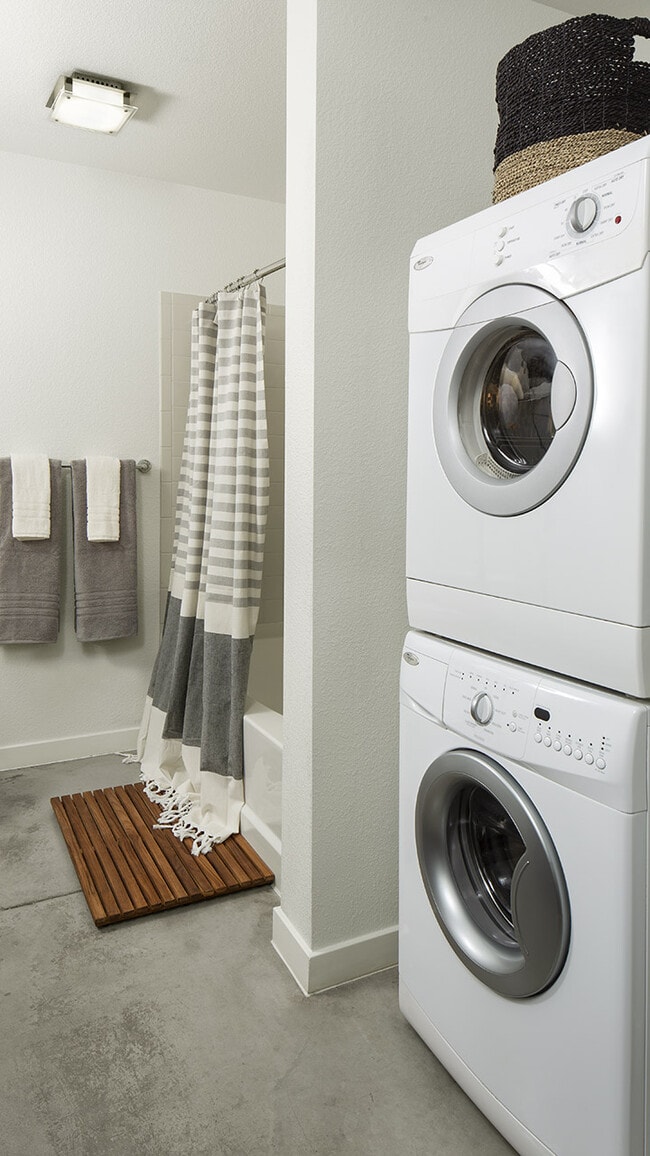 Apartment Bathroom with soaking tub and in-home washer and dryer. - Griffis Union Station