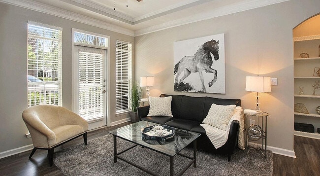 Experience elegance and comfort in this beautifully lit living room. - Verdant Peachtree Creek