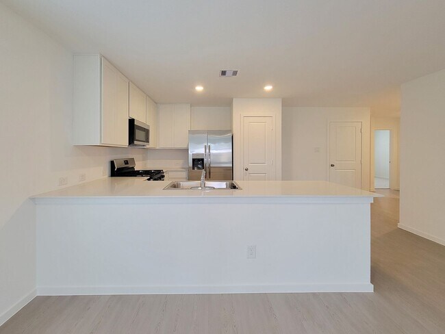 Photo - This lovely single-level home showcases a spacious open floorplan shared between the kitchen, din...