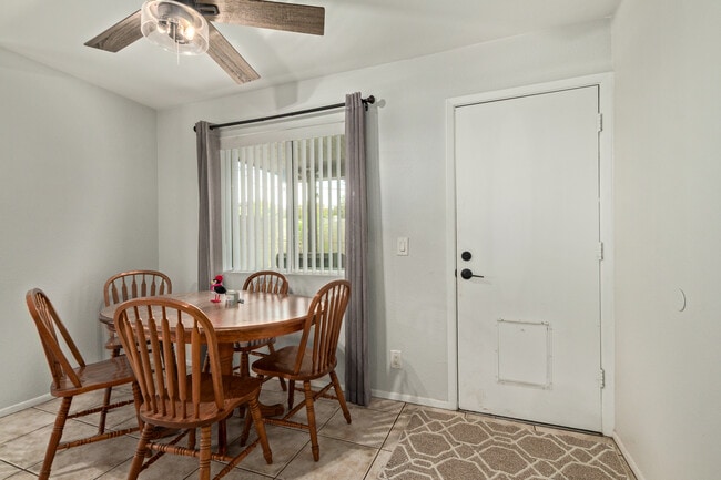 Dining room with backyard door and view of covered patio yard - 115 W 10th St Unit 10th and Ash condo 115