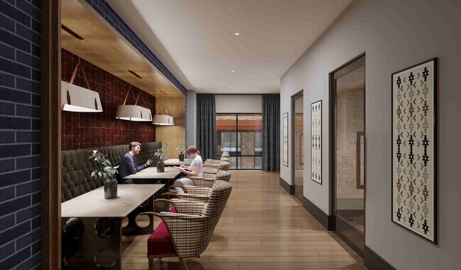 A flexible business lounge offering collaborative seating, vibrant artwork, and a polished environment for work or study. - The Everett-Nashville Yards