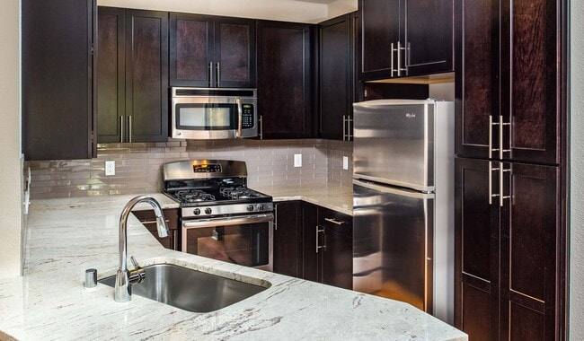 Modern kitchen with stainless steel appliances, granite countertops and premium cabinetry