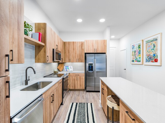 Experience culinary excellence in Modera Trinity's gourmet kitchens, adorned with sleek quartz countertops and stylish tile backsplashes.