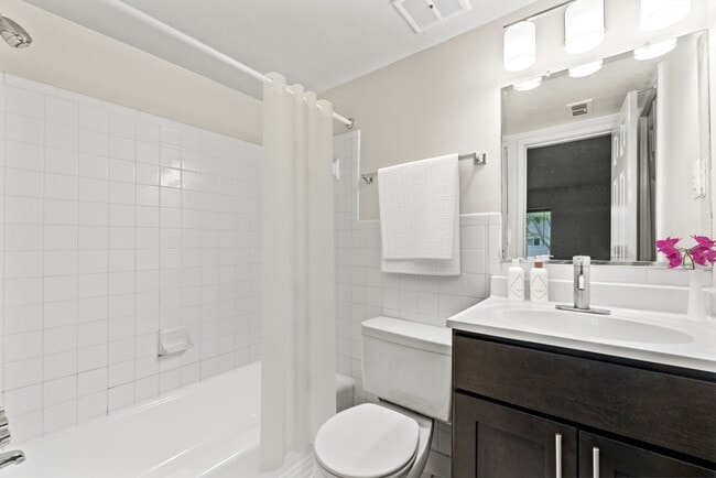 Updated bathroom with tub and shower and modern cabinetry