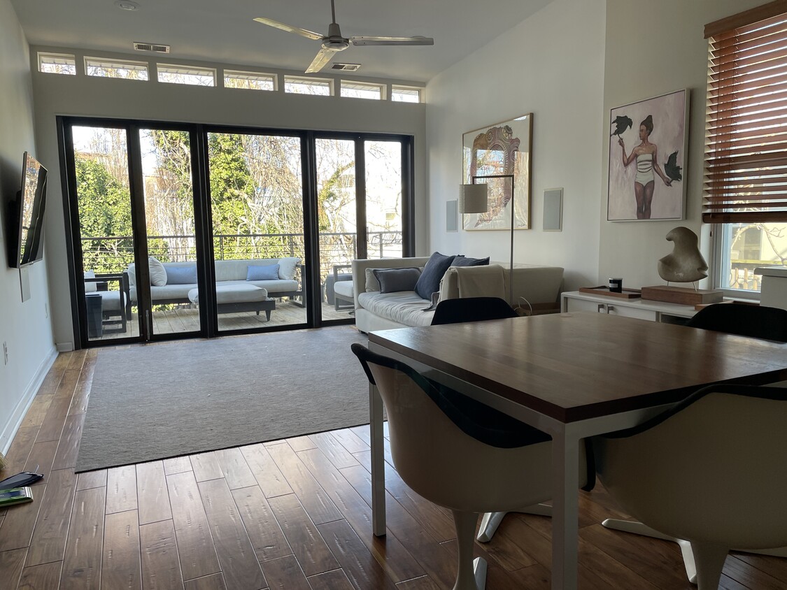 View from the open plan kitchen, to the living room and on to the patio deck. - 1003 P St NW (Washington, DC)