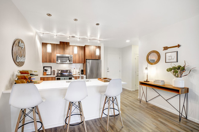 Bright, functional kitchens with stainless steel appliances and quartz countertops - The Whittaker Apartments