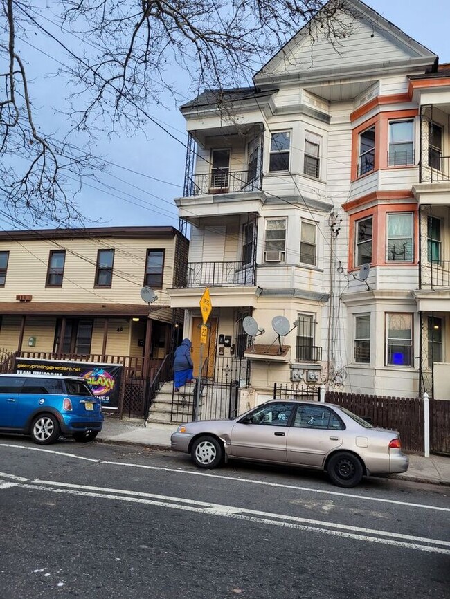 Building Photo - 3 bedrooms on the 3rd Floor with Central Hot Air, and an Available backyard