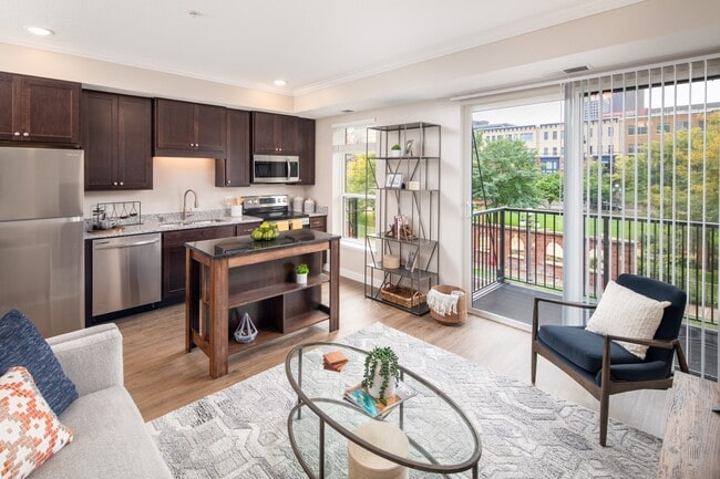 View of modern living room and kitchen area at The Whitley - The Whitley Apartments