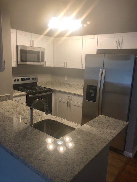 Kitchen with granite tops, stainless steel appliances - 1208 Mist Wood Ct Condo Unit 304