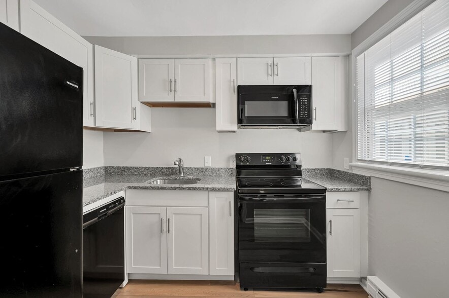 Stunning new renovations include sleek black appliances, and white shaker cabinets.
