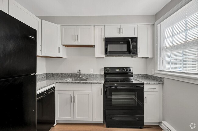 Stunning new renovations include sleek black appliances, and white shaker cabinets. - Linden at Highland Park Rental