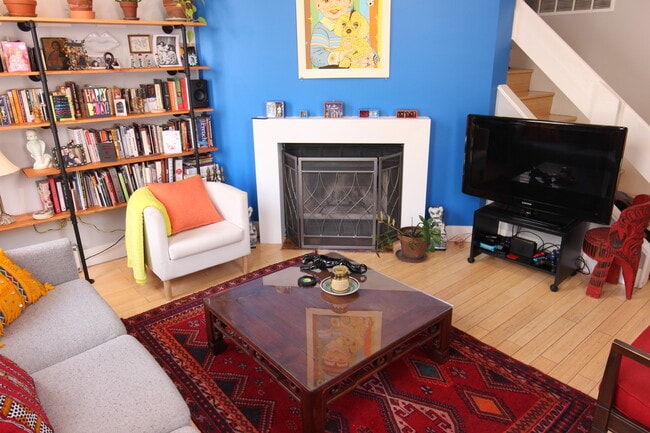 Living room with built in bookshelves and wood burning fireplace - 1626 Carroll St