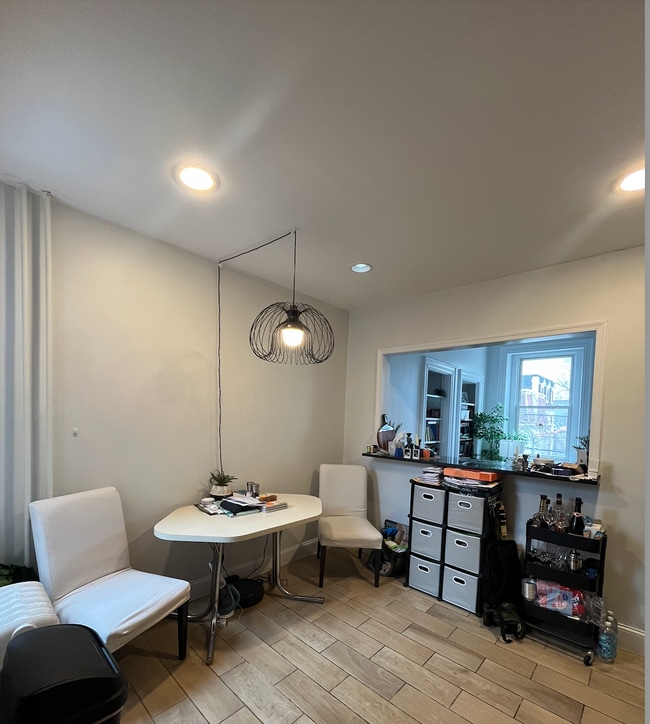 Kitchen with breakfast bar facing living room - 3702 Spring Garden St Unit #3