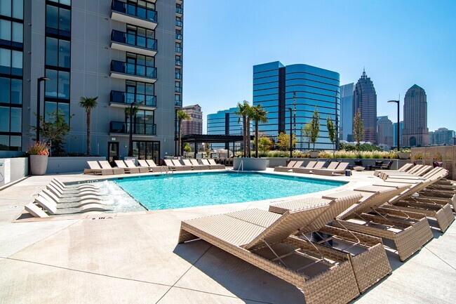 Luxe pool with chaise lounges and cabanas. - Ascent Midtown Rental