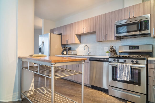 Modern kitchens with stainless steel appliances and contemporary finishes at Spectra at Sibley Squar