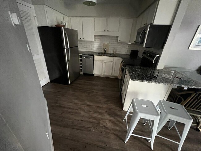 Kitchen With Microwave, Fridge, And Dishwasher
