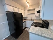 Kitchen with granite countertop and black/stainless steel appliances