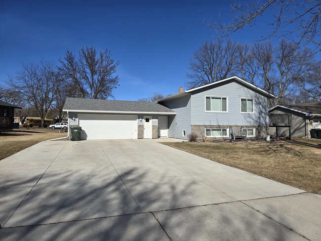 Front of the house with attached garage extra large driveway and available street parking - 775 Madson Ave SW House Unit Upper