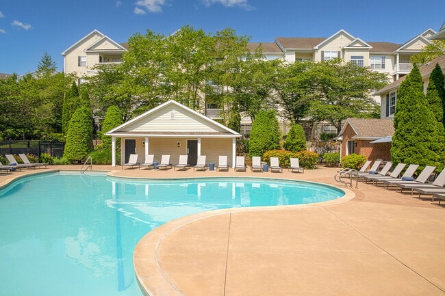 Expansive resort-style heated swimming pool with fountain and sundeck