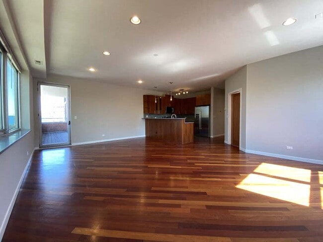 Spacious living area with hardwood floors