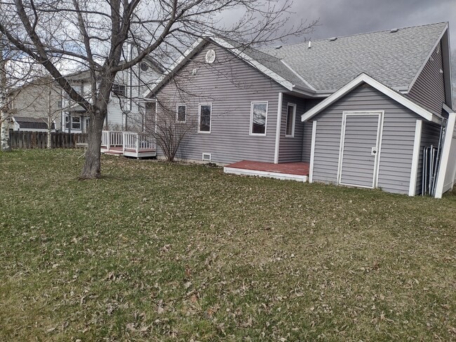 View of backyard and back of house with the shed