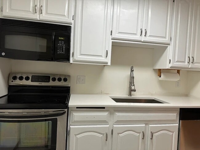 New quartz countertops, sink, garbage disposal and dishwasher installed in July 2025 - 35 Nathan Ln N Condo Unit 121