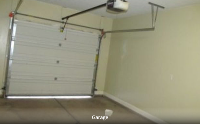 One car garage with shelving. - 1288 N Cedar Blvd. #43 Townhome