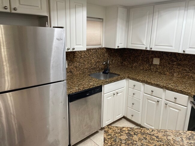 Kitchen with marble countertop - 8215 Lake Dr Unit 307 B