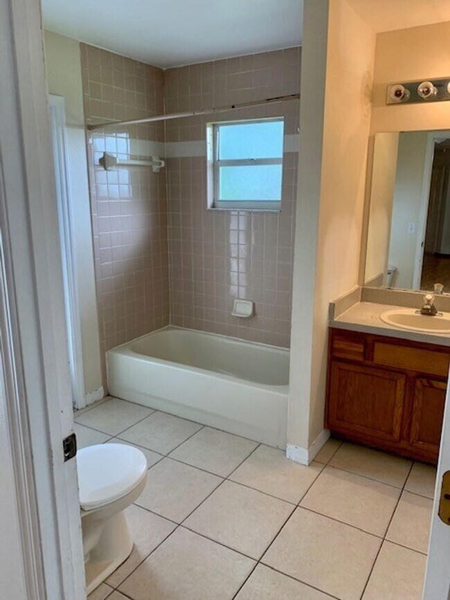 Photo - Available NOW! NEW FLOORS AND PAINT! Lovely 3/2 in Poinciana! HUGE fenced yard and NO CARPET!