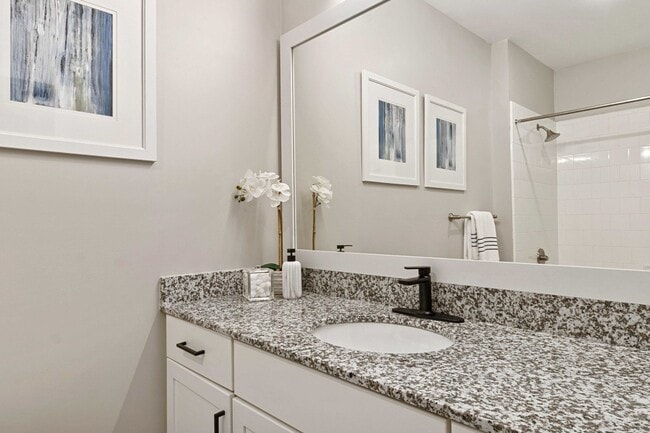 Upgraded Baths with Framed Mirrors and Matte Black Fixtures