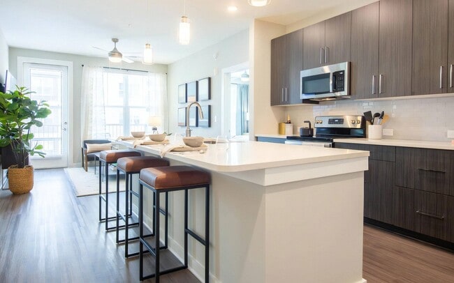 Open Kitchen Featuring Bar Seating and Adjacent Living Area - The Elden Galleria Rental