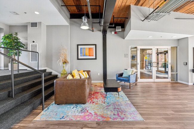 Open-concept living area featuring exposed wood ceilings and contemporary furnishings