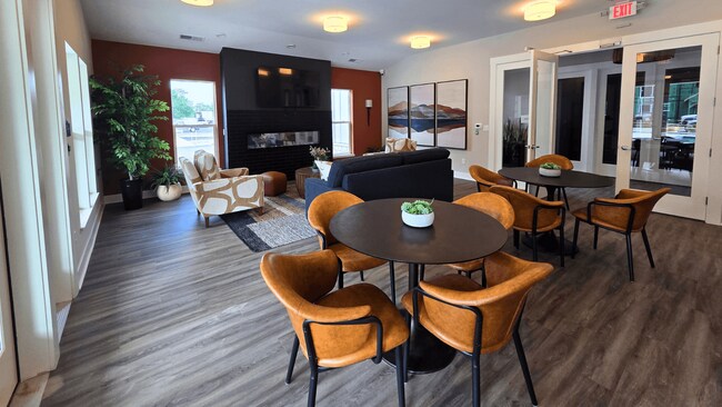Clubhouse lounge area with seating, television, and fireplace at Greenwood Commons in Delaware, OH.