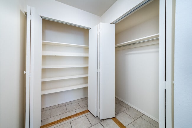 Studio - dressing room featuring two closets, additional closet by entry - Stepping Stones