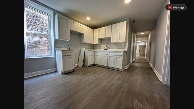 Newly renovated kitchen with white shaker cabinets, new countertops, and stainless steel appliances - 5653 S May St Unit 1