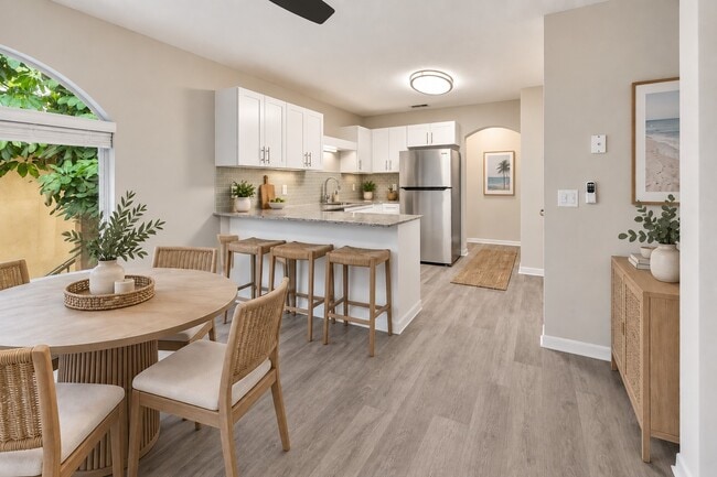Elevate your lifestyle at Indian Hills with this modern kitchen featuring sleek appliances and stylish finishes. Ample space combined with a cozy dining area creates the perfect environment for entertaining. Explore your new home today!