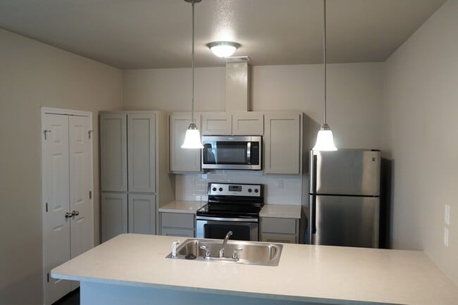 Kitchen with Shaker Style Cabinets comes with Stainless Steel Fridge