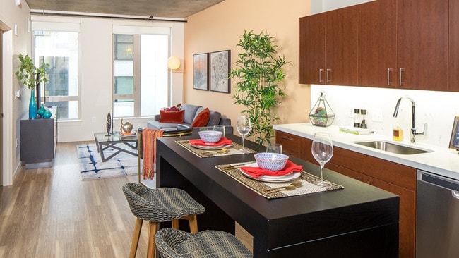 Modern kitchens outfitted with stainless steel appliances, and quartz countertops with tile backsplashes