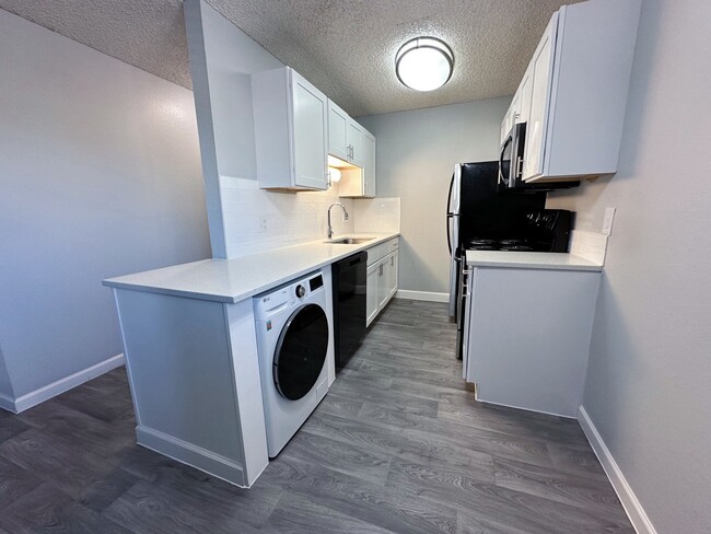 Kitchen with Washer/Dryer combo - Reserve at Water Tower Village Apartments