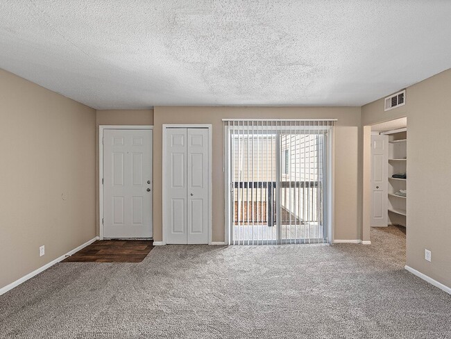 Carpeted Living Room with Balcony