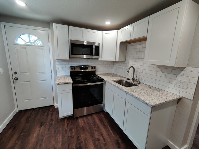 Kitchen with Stainless Steel Appliances and Garbage Disposal - 1814 26th St W Apartments Unit 2606