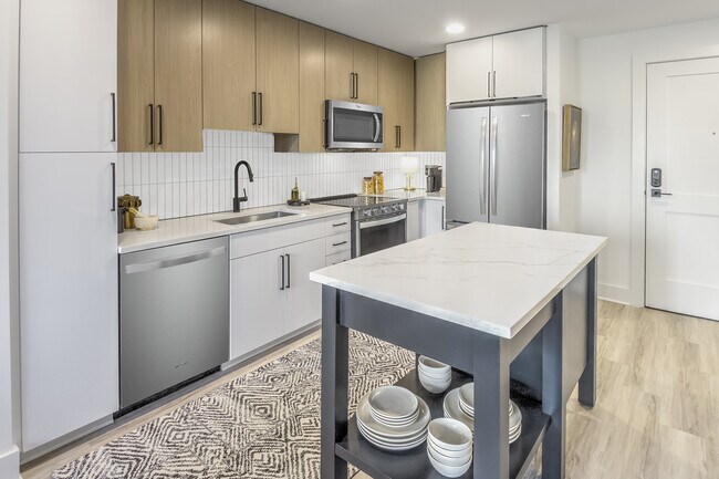 Contemporary kitchen with two-tone cabinetry - The Camille Apartments Bethesda