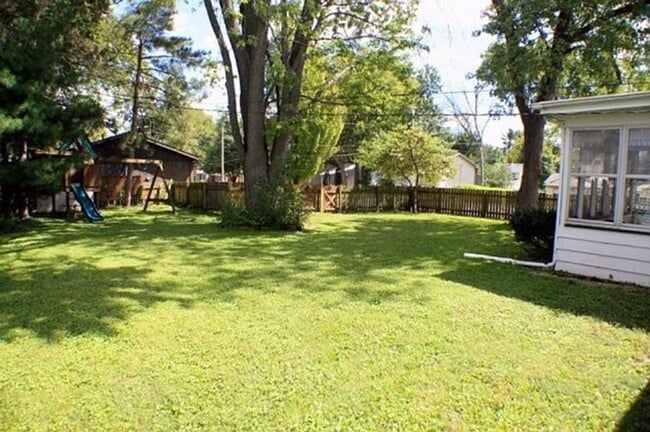 Photo - Corner Lot Charm: Spacious 3-Bed Home with Fireplace and Prime Location