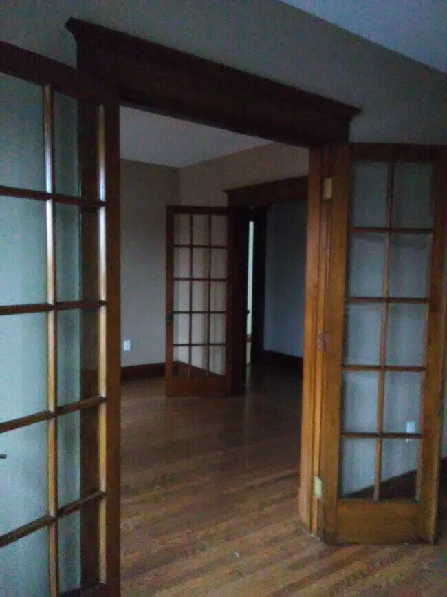original beautiful french doors, hardwood floors and woodwork - 3210 Main St Unit Apartment 1
