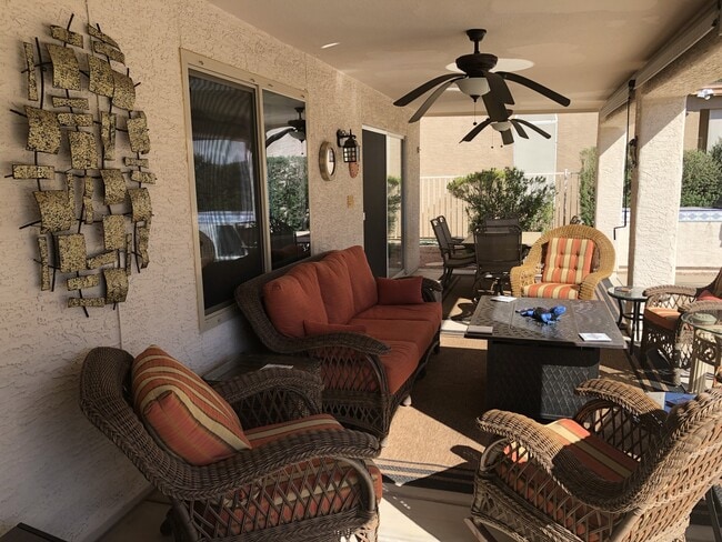 Back patio area includes barbecue and wind down shades. - 9513 E Champagne Dr