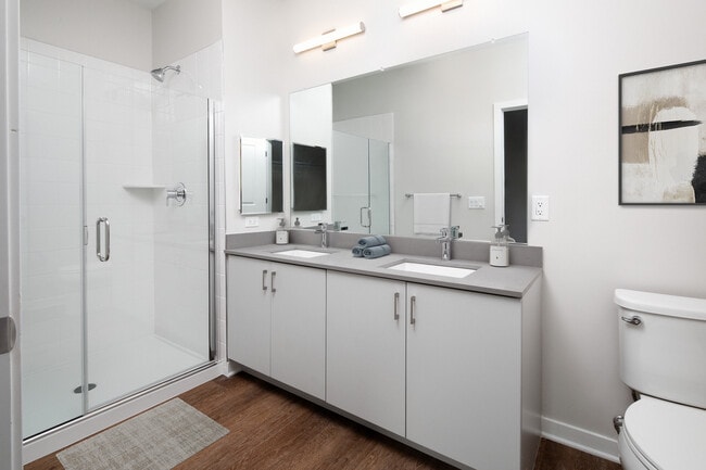 Design Collection I (North Building) Bath with white cabinetry, grey quartz countertop, and hard surface flooring