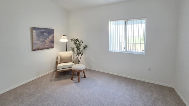 Unwind in a bright, oversized bedroom featuring plush carpeting, a generous closet, and plenty of room for a king-sized bed and additional furniture.