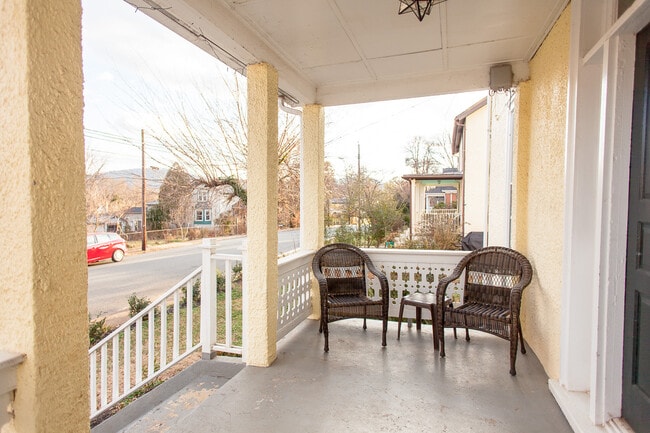 People watch on front porch - 205 Douglas Avenue