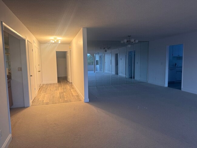 Entry hall back into 2 bedrooms; dining room with upgraded chandelier - 8701 Delgany Ave Unidad 204
