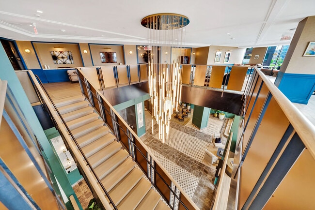 Lobby grand staircase leading to the coworking lounge.
